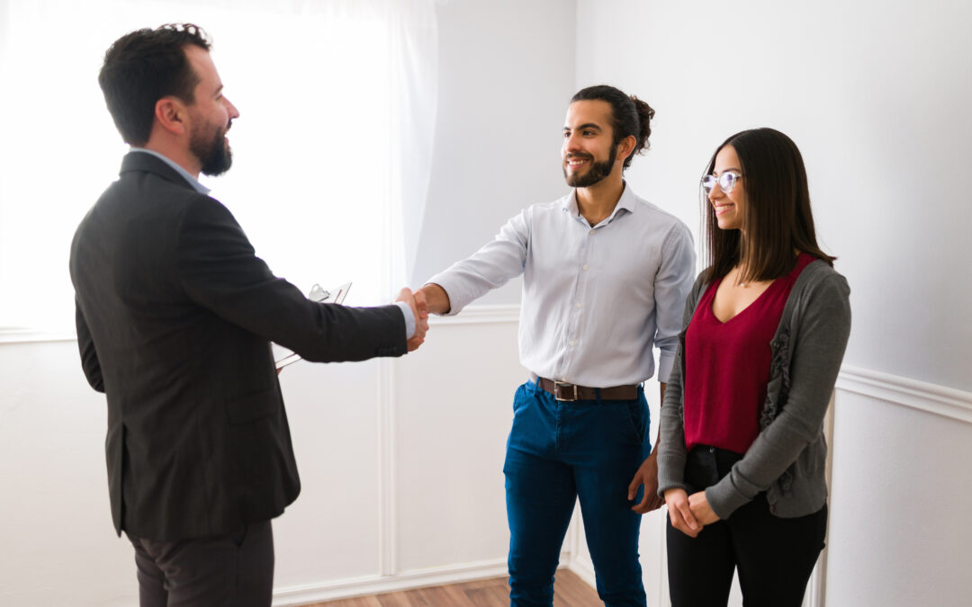 Couple shaking hands with leasing agent on an apartment tour